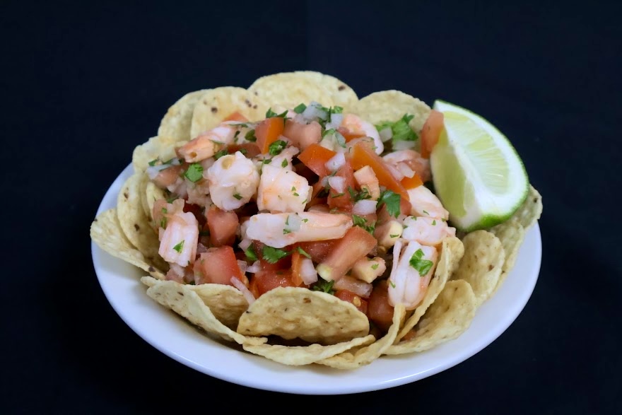 Shrimp ceviche served with tortilla chips and lime