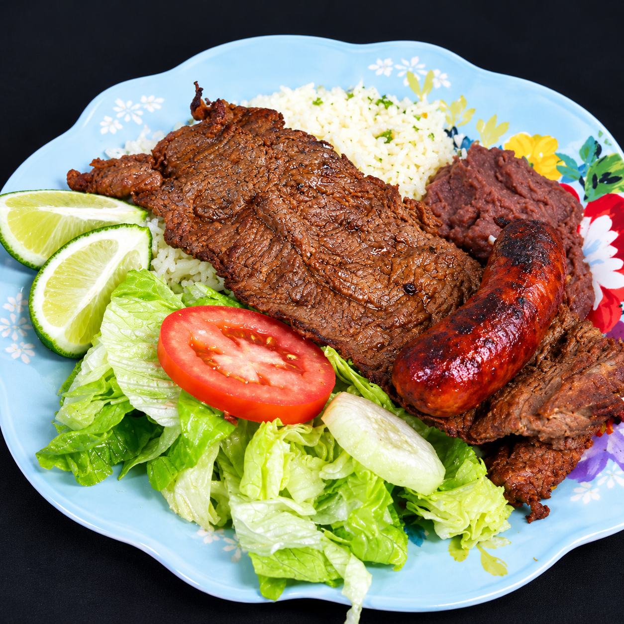 Carne asada plate with chorizo, rice, beans and salad