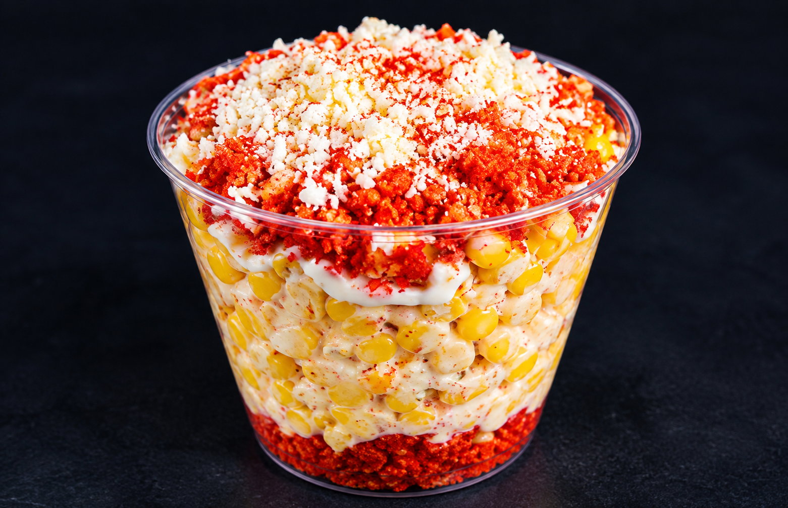 Elote cup with corn, crema, cheese and hot chips topping